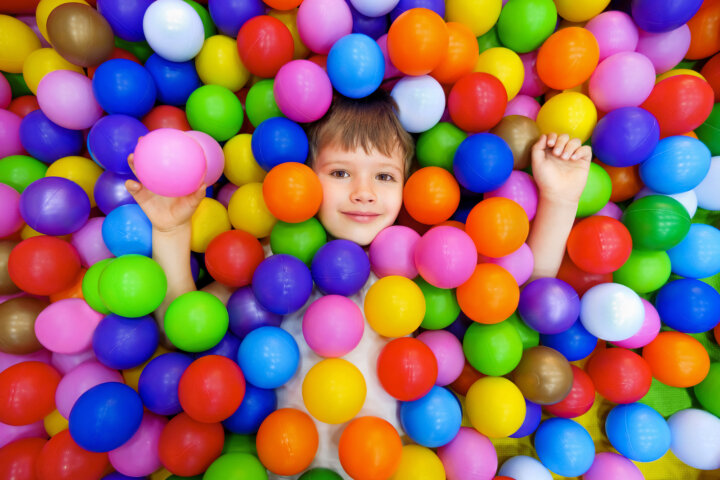 Smile Kid Lying Colorful Plastic Balls Pool. Colorful Balls Dry