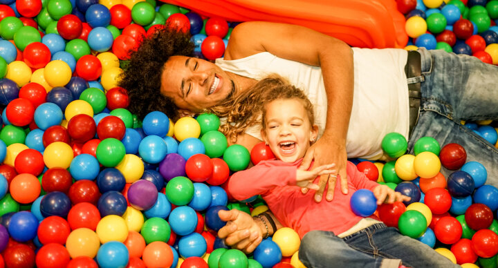 Young Father Playing With His Daughter Inside Ball Pit Swimming